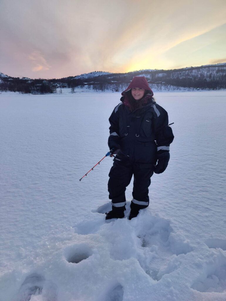 Ice fishing on a frozen fjord in Kirkenes.